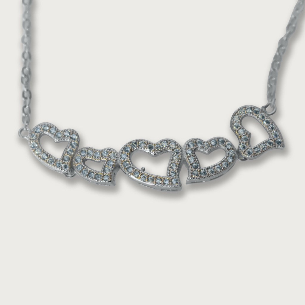 Brazalete de plata italiana con baño de rodio, adornado con corazones y piedras preciosas, un diseño elegante y sofisticado.